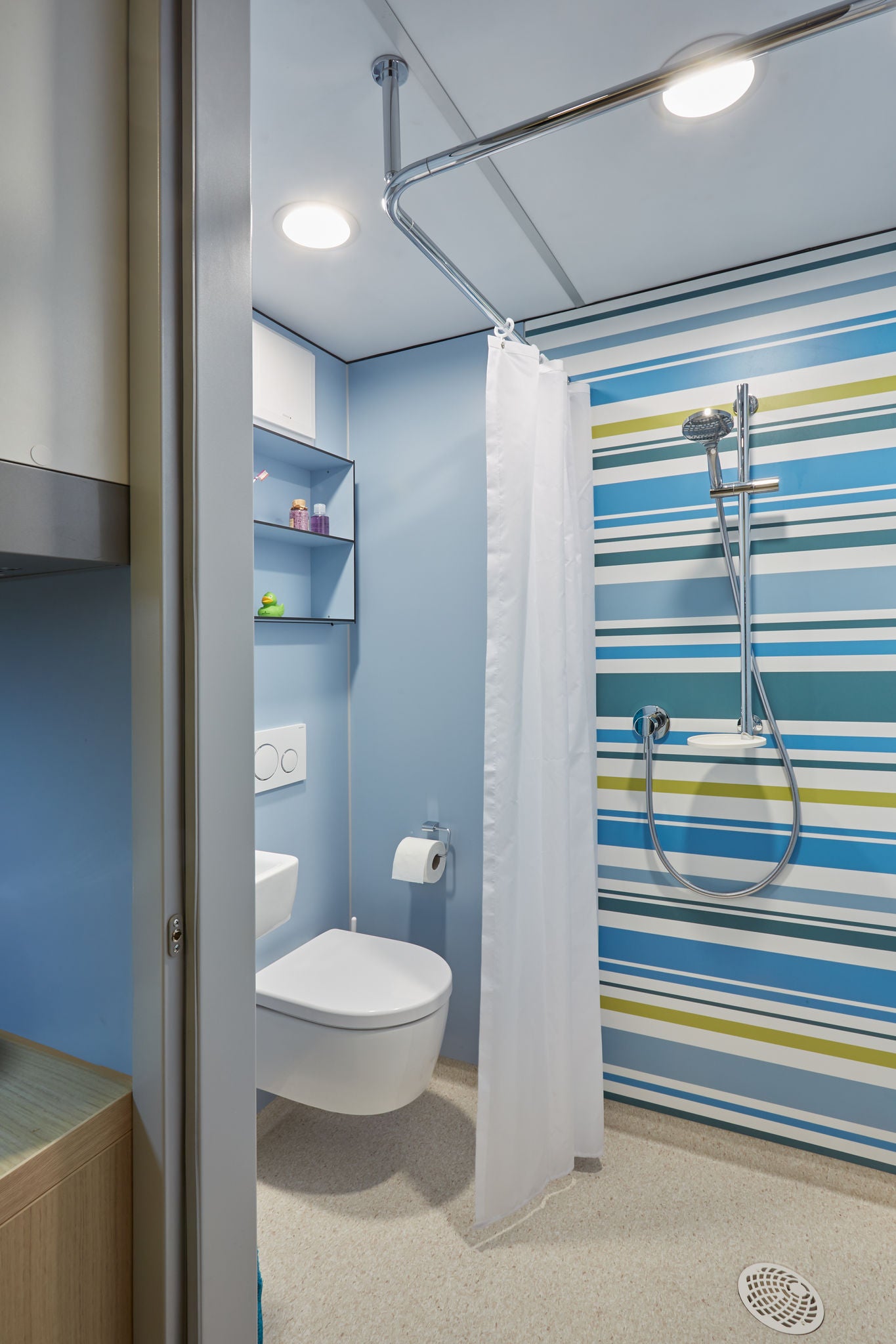 Shower area with WC in a system bathroom in a student residence with IXMO fittings and accessories from the SMART.2 and PLAN series