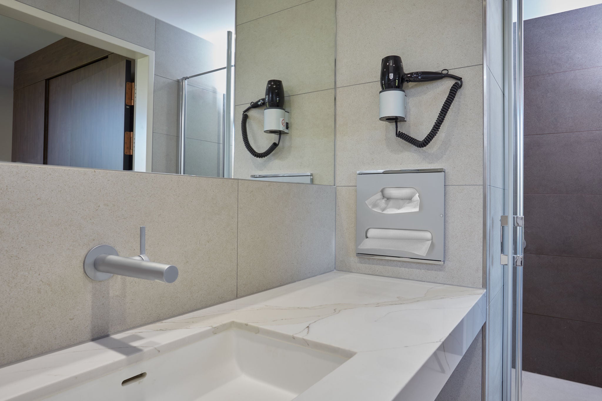 Washbasin with IXMO single lever basin mixer and hair dryer at the Eisenberg rehabilitation clinic