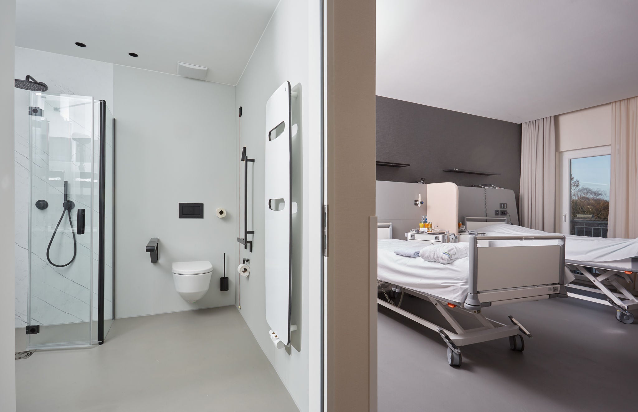 Black fittings in shower and WC with black accessories in the room at RWTH Aachen-Franziskus